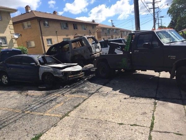 KMK wrecker towing burned-out vehicles on a Milwaukee street